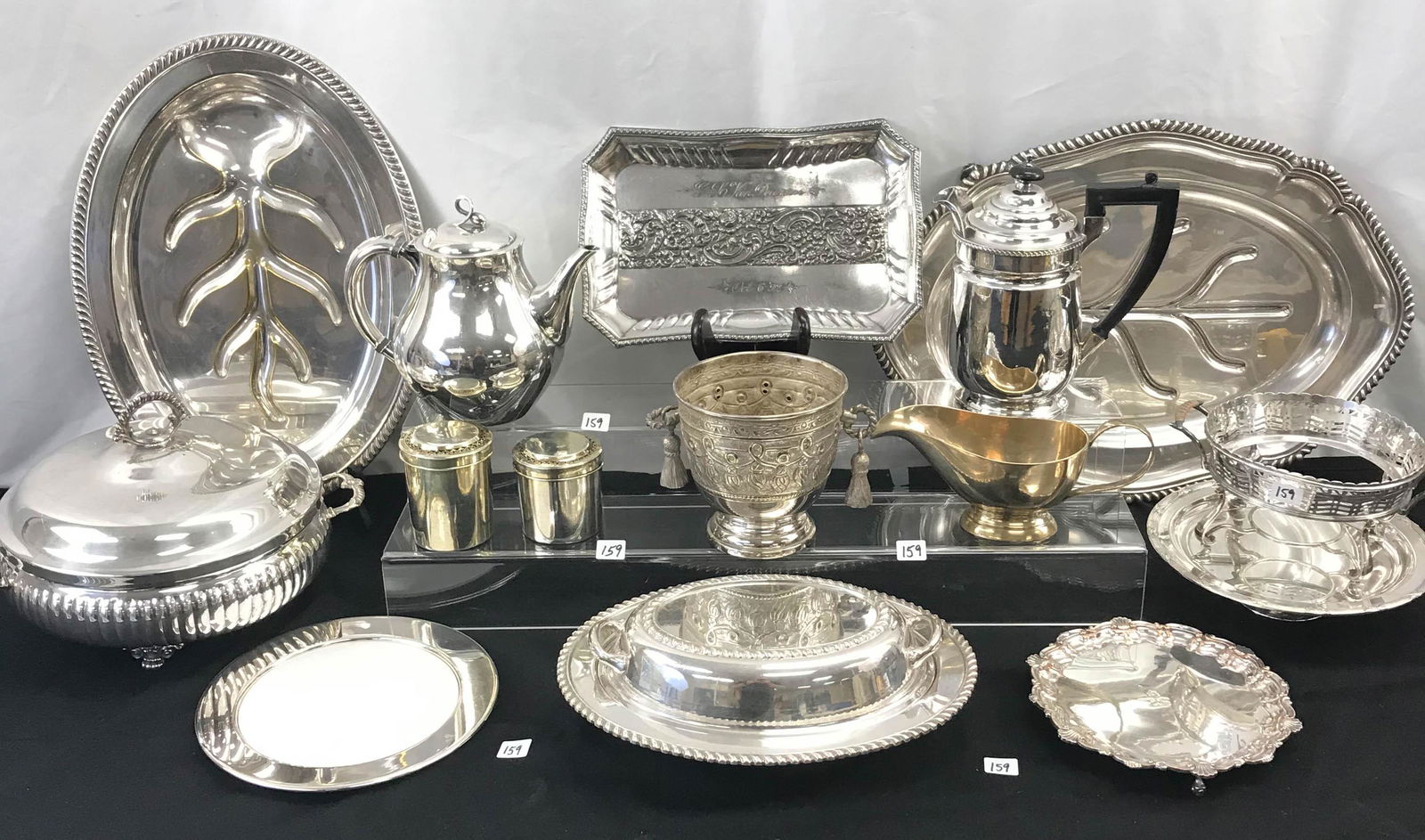 Large Mixed Group of Quality Silverplate: This large mixed group of quality silver plate from the late 19th and 20th century include a Reed and Barton "Americana" pattern tea pot, an English small ice water pitcher with an ebony handle and fi