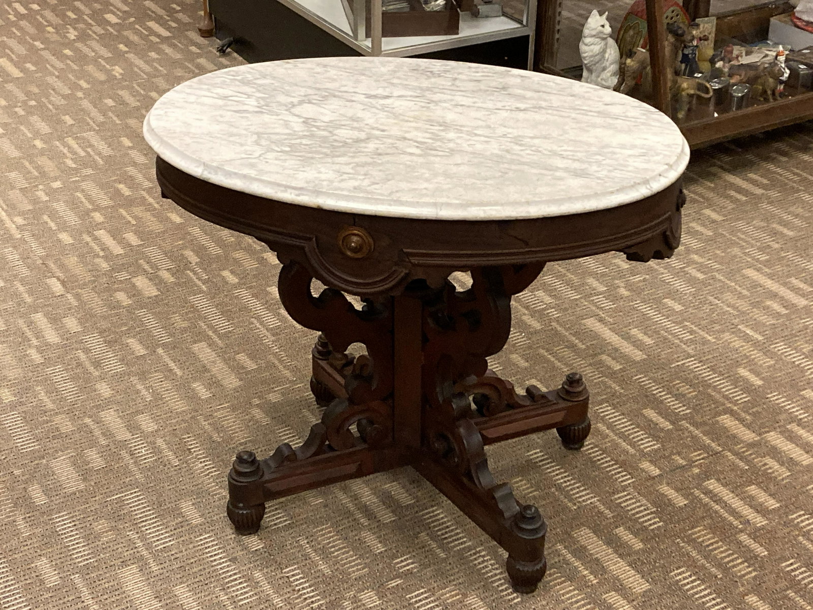 Outstanding Oval Marble Victorian Table: Antique oval white marble top table in the Renaissance style, in Walnut rosettes and race track trim on bun feet. This table has some minor losses it measures 28" tall X 34" across X 25" deep. Walnut