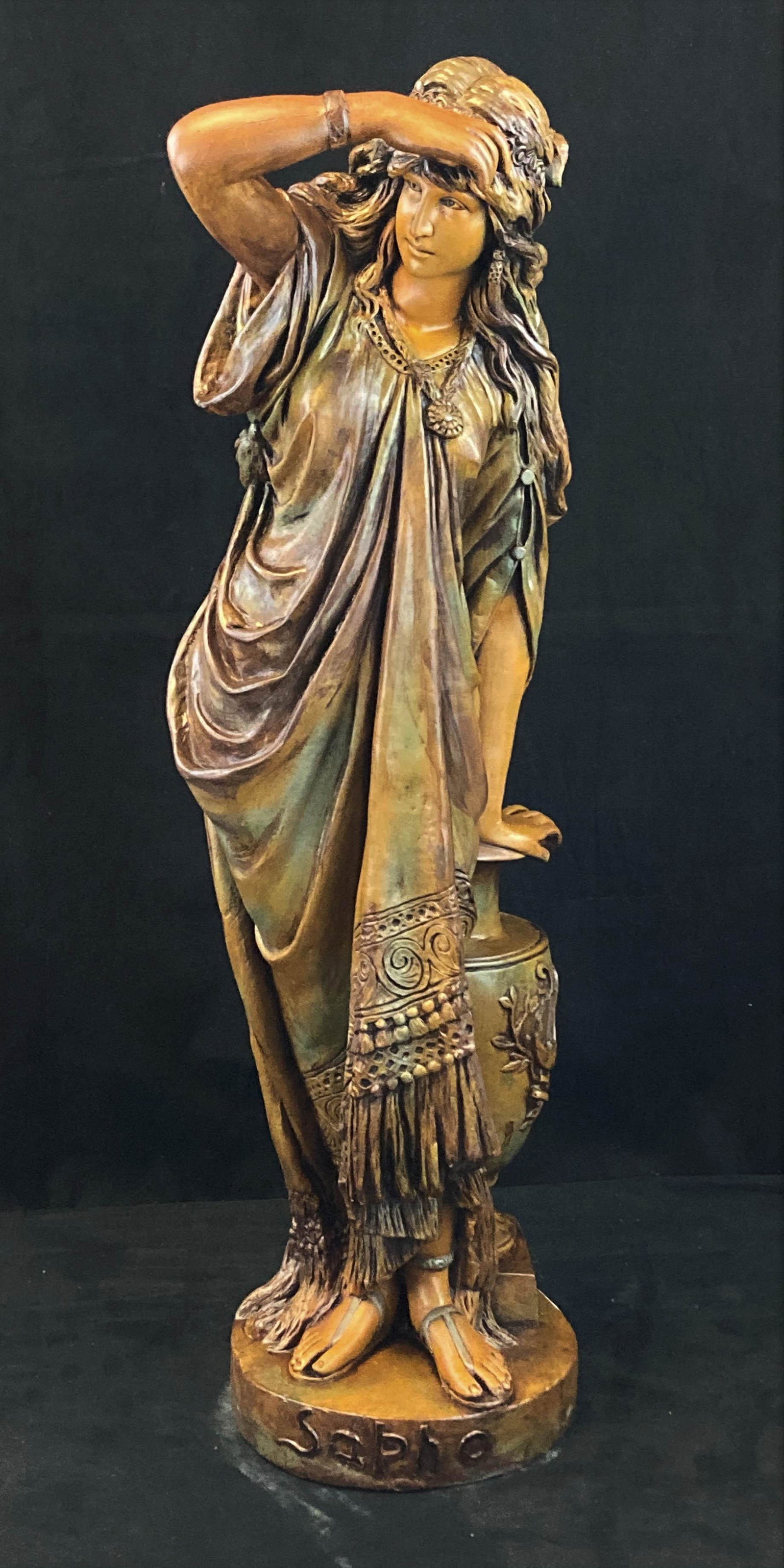 Victorian Terracotta Statue of Sapho with an Urn: Antique Terracotta statue of a Grecian woman in elaborate dress and sandals leaning on a fancy urn gazing in to the distance signed in front Sapho and numbered on the back measuring 33" tall.