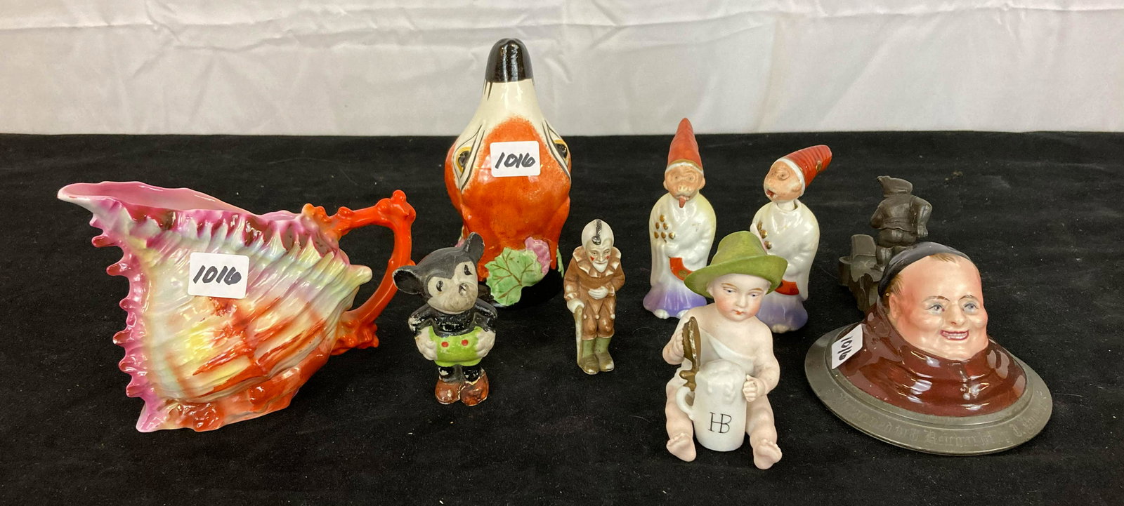 Large Lot of Various Miniatures and More: Large lot of miniatures and more to include a seashell creamer, a fox head, a beer stein cover of a monk, two porcelain knotters where their tongues come out of their mouth, a little boy holding a ste