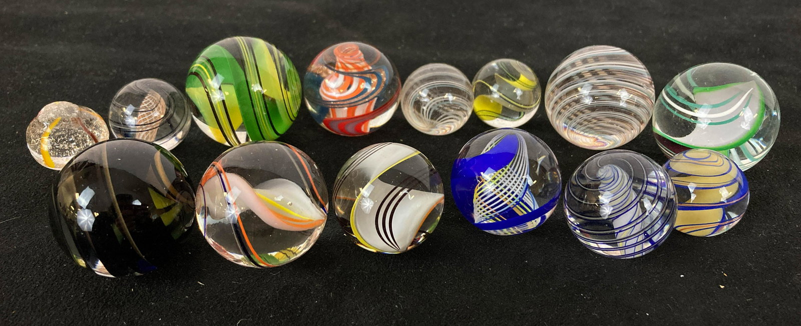 14 Hand-Blown Marbles: 14 hand-blown sulfite swirl marbles to include cobalt swirl, igneous swirl, and more.
