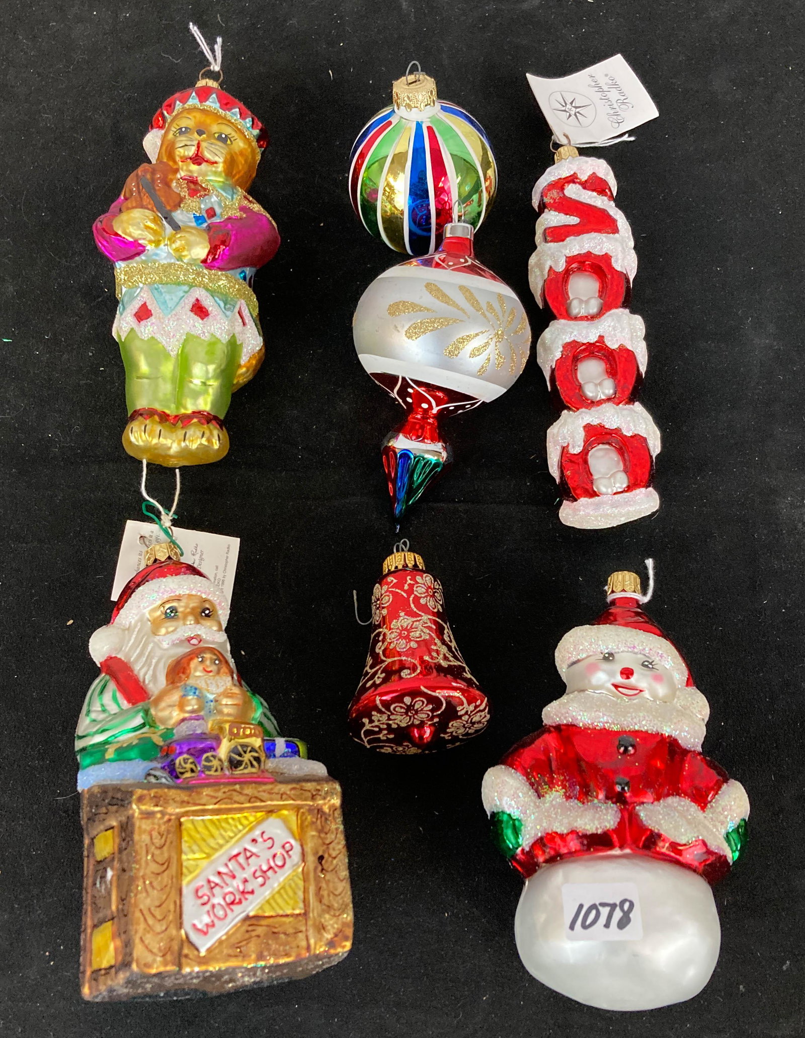 Lot of Radko & Other Ornaments: Radko & other ornaments to include Santa's workshop, snowman on ball, large kitty with a fiddle, the year 2000, and more.