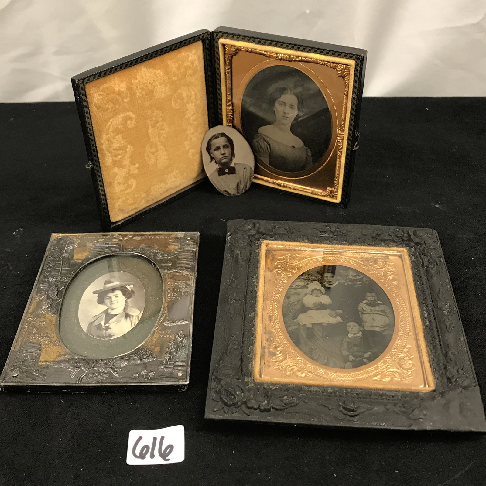 Group of 1800's photographs: This group of 1800's early photographs include an ambrotype of a mother and her 3 children in a gutta percha frame, a Victorian portrait in a 1900's metal souvenir frame from Wisconsin Dells, a small