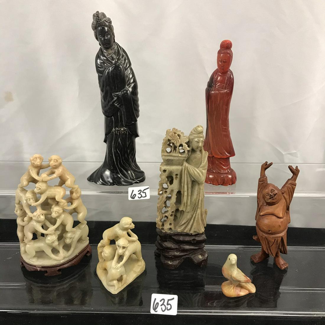 Group of Finely Hand Carved Oriental Figurines: This group of finely hand carved Oriental figurines include a dark grey horn goddess figurine (7" tall), a hand red horn goddess figurine (6" tall), a carved stone goddess figurine standing next to an