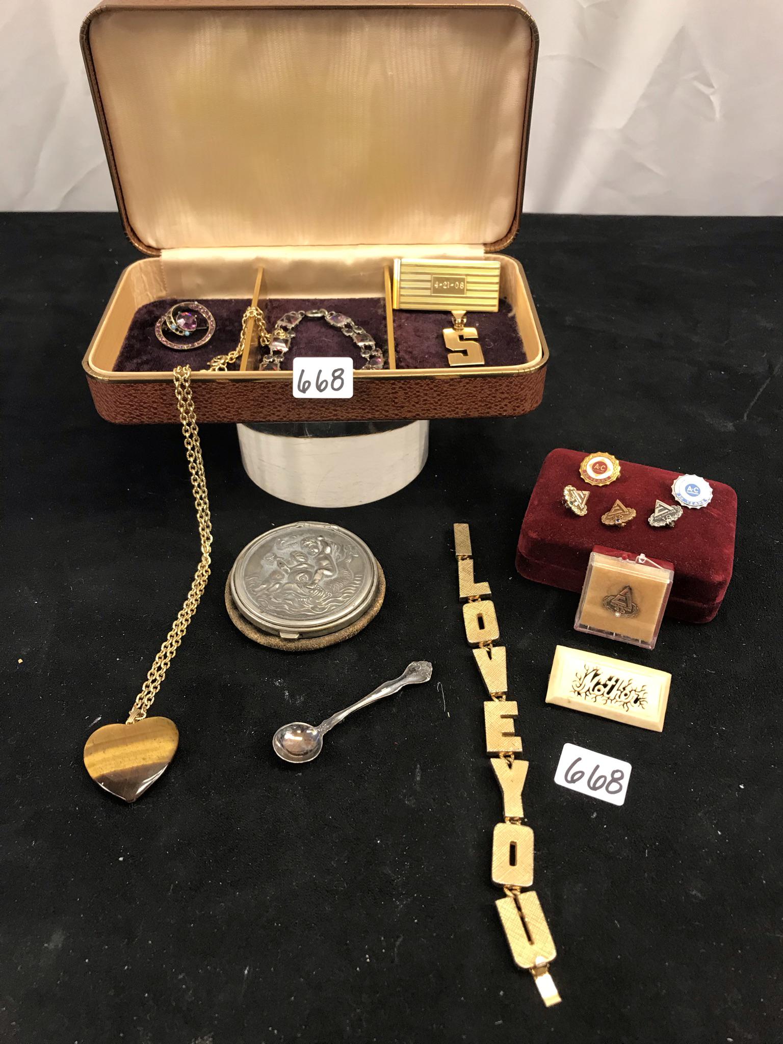 LOT OF COSTUME JEWELRY, STERLING, MORE!: This mixed group of costume jewlry includes a sterling silver spoon brooch, some sterling Allis Chalmers pins, a multi colored rhinestone circle brooch, a tiger's eye heart on a gold tone chain, a lea
