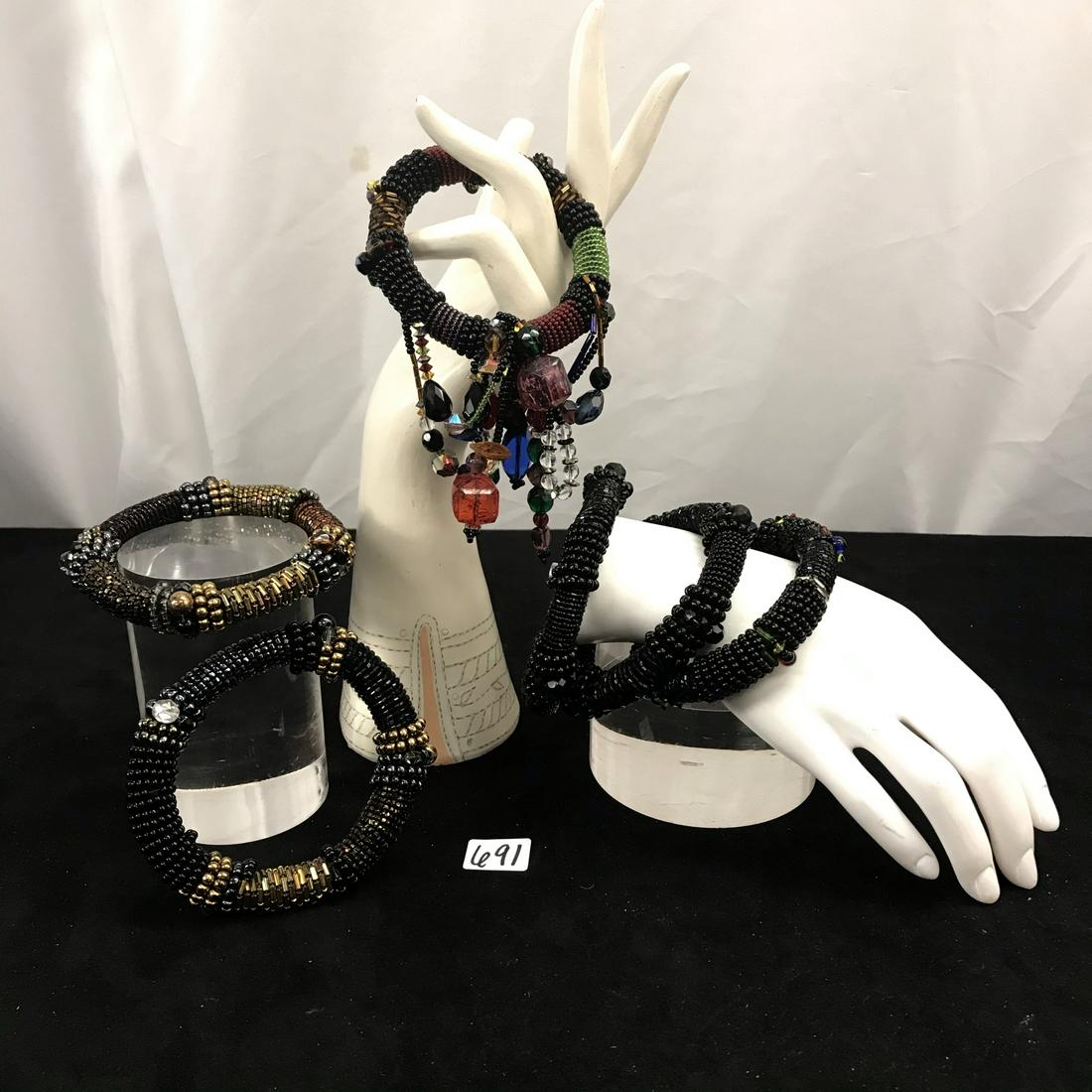 Group of 6 Hand Beaded Bangle Bracelets: This group of 6 hand beaded bracelets are in excellent condition.