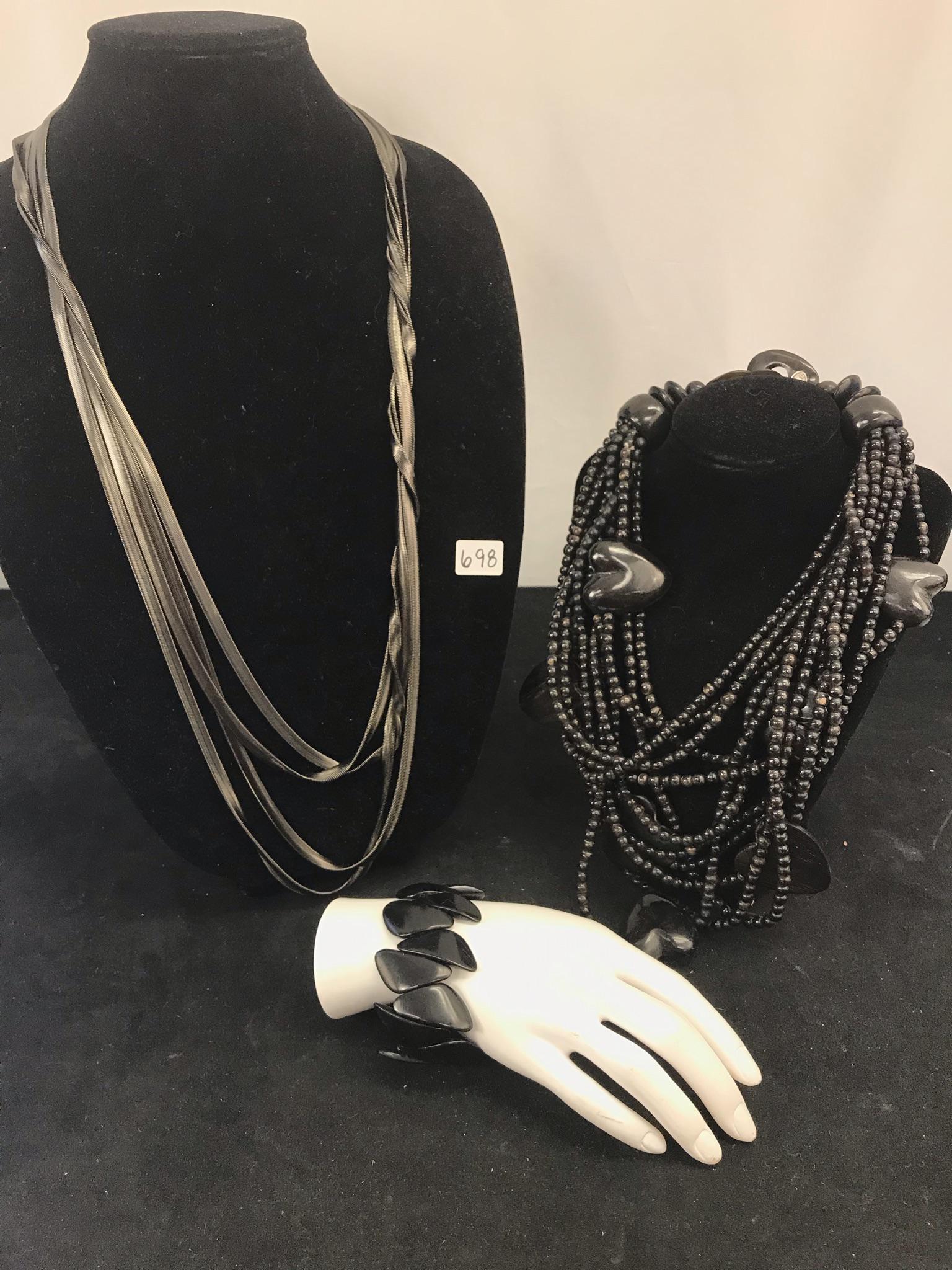 Gerda Lynggaard for Monies Horn Necklace: This group of high quality ladies jewelry include a Gerda Linggaard for Monies Copenhagen heart and multi-strand bead necklace made of horn, a horn triangular bead expandable bracelet, and a multi str