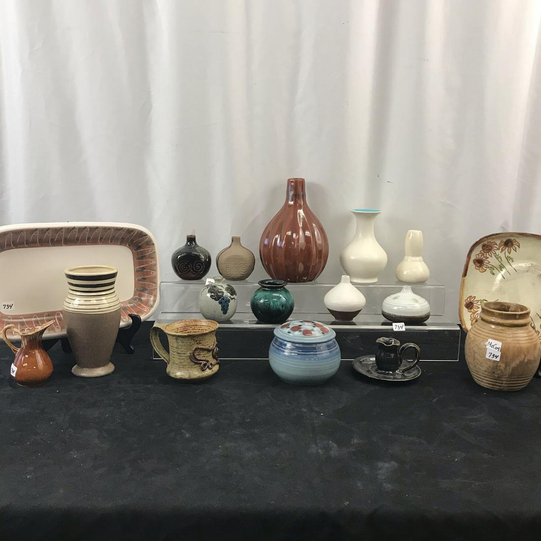 Large Group of Mid Century Pottery: This large group of mid century pottery include small Japanese bud vases, a rectangular platter, an earthenware McCoy ginger jar shaped vase, a signed lidded blue jar with decorative top, and more!