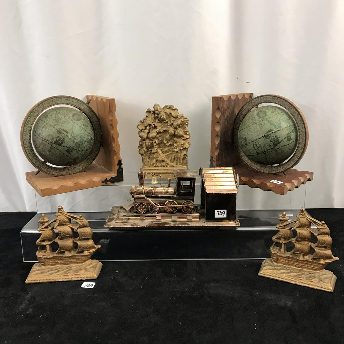 MCM Bookends, Train Music Box: This group of MCM objects include a pair of wood old world globe bookends, a pair of Arts and Crafts US. Constitution cast metal bookends, a copper moving part train music box that plays Chatanooga Ch