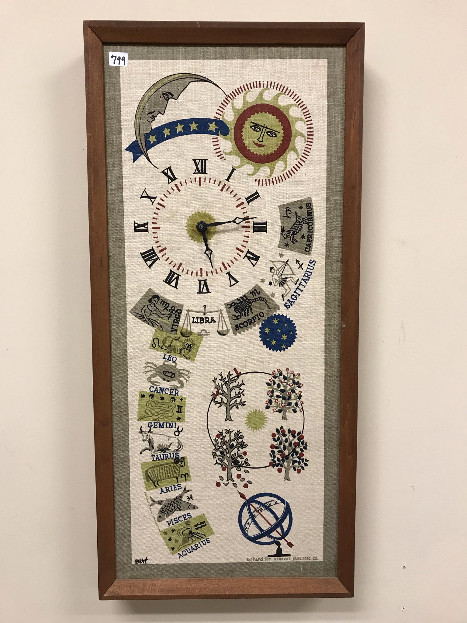 MCM Wert General Electric clock: This 1970's General Electric Zodiac clock was made by hand by Wert. It has a cloth face, teak body and is in working. It measures 28" tall X 13" across, 2.5" deep.