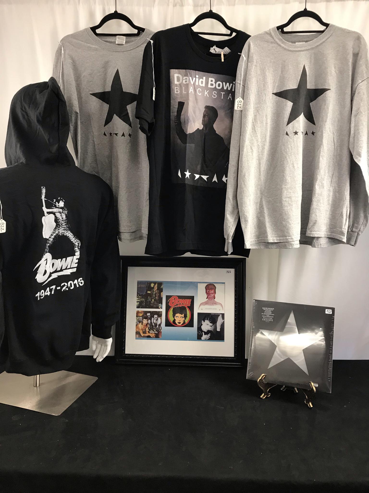 David Bowie Black Star Memorabilia, Album: This group of David Bowie memorabilia include a factory sealed black Star Record album on transparent vinyl (2016), a framed print featuring images of 5 of Bowieâ€™s album covers (19" tall X 23"