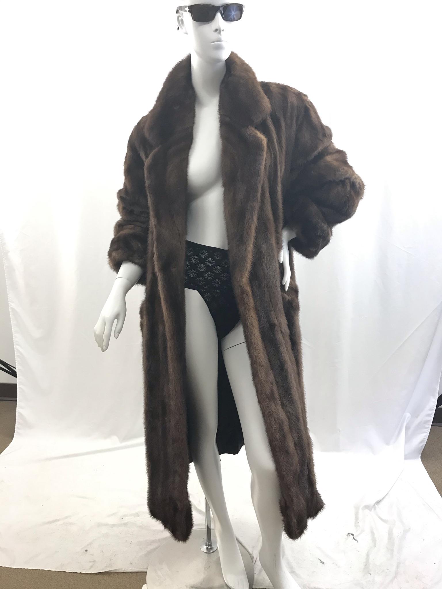 Ladies Full Length Mink Coat By Manor Furs: This Manor Furs of Chicago ladies full length mink coat has fold over cuffs, and a shawl collar. There is a small repairable split very near the hem. And some wear in one spot on the hem It is an appr
