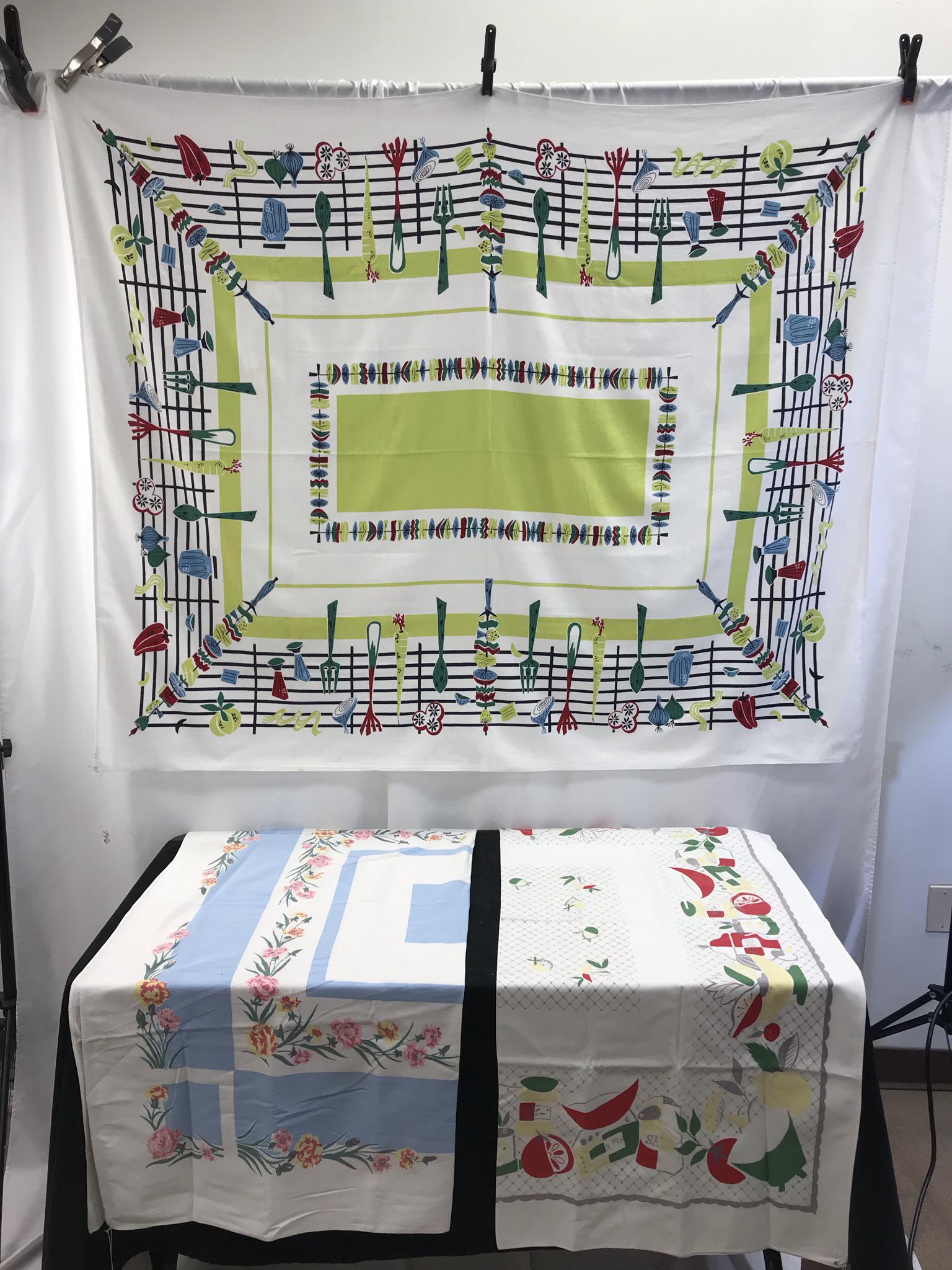 3 MCM Novelty Print Tablecloths: Thes 3 MCM novelty print 1950's tableclothes include a shishkebob grilling themed table cloth that measures 62" long X 51" across, a 50's kitchen themed table cloth that measures 44" X 50" (small hole
