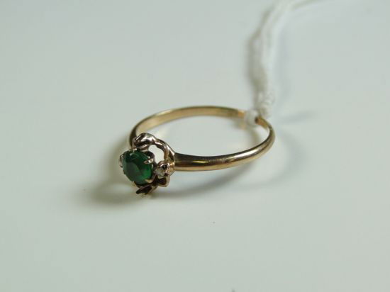 10K gold emerald ring with 2 diamond bagguettes- (: 10K gold emerald ring with 2 diamond bagguettes- (missing 2 diamond bagguettes) Est. Value $75-$85