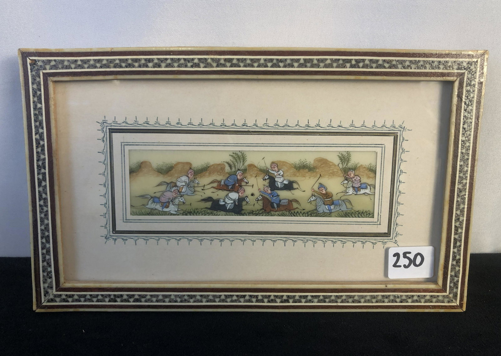 Hand-Painted Bone Plaque of Warriors on Horses: Chinese or Mongolian Warriors on horseback hand-painted on bone in an elaborately inlaid frame that measures 5" tall X 8.5" across.