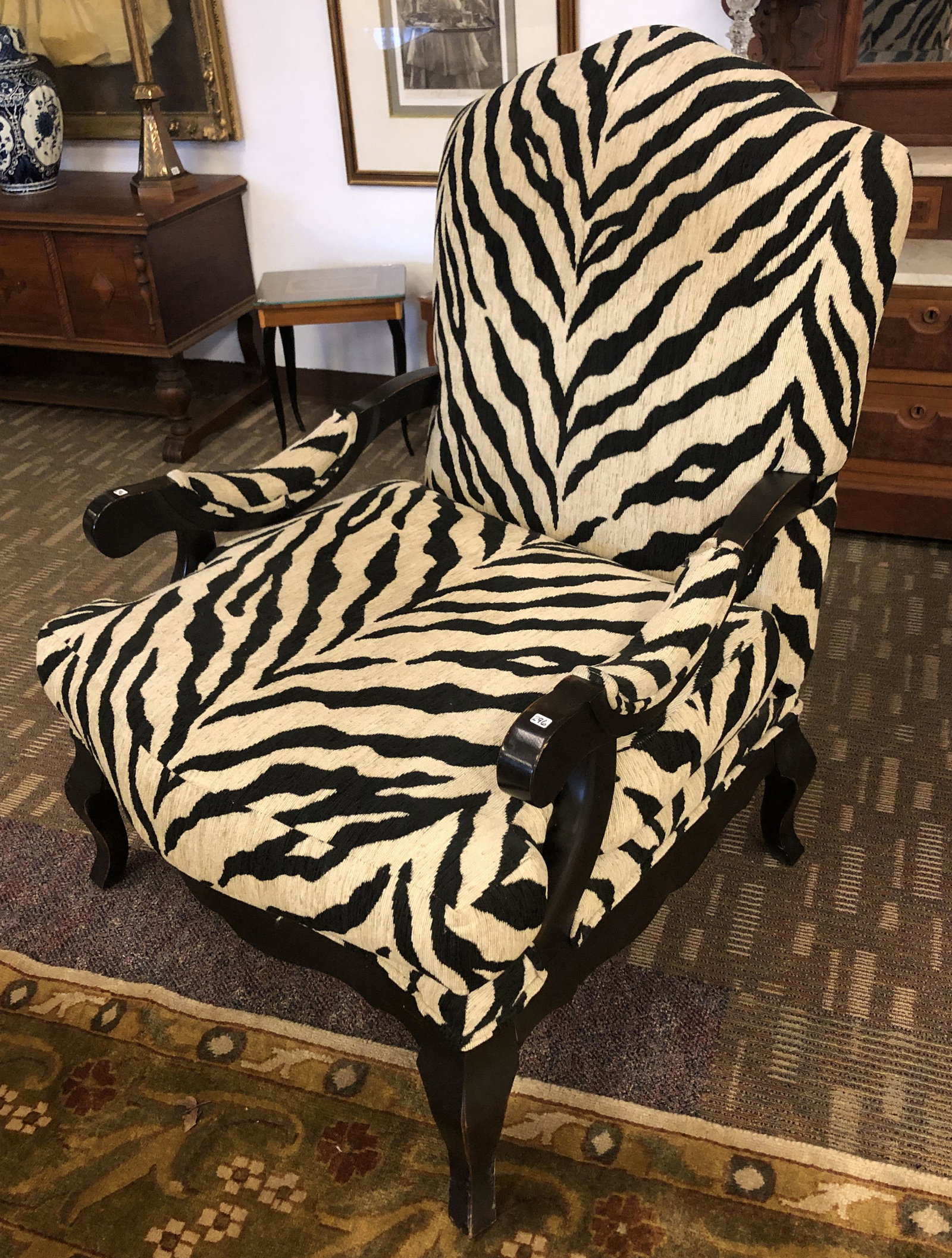 Oversized Zebra Upholstered Armchair: This designer oversized contemporary zebra upholstered armchair has a rustic ebonized finish to the wood portions and measures 44" X 33" X 26".
