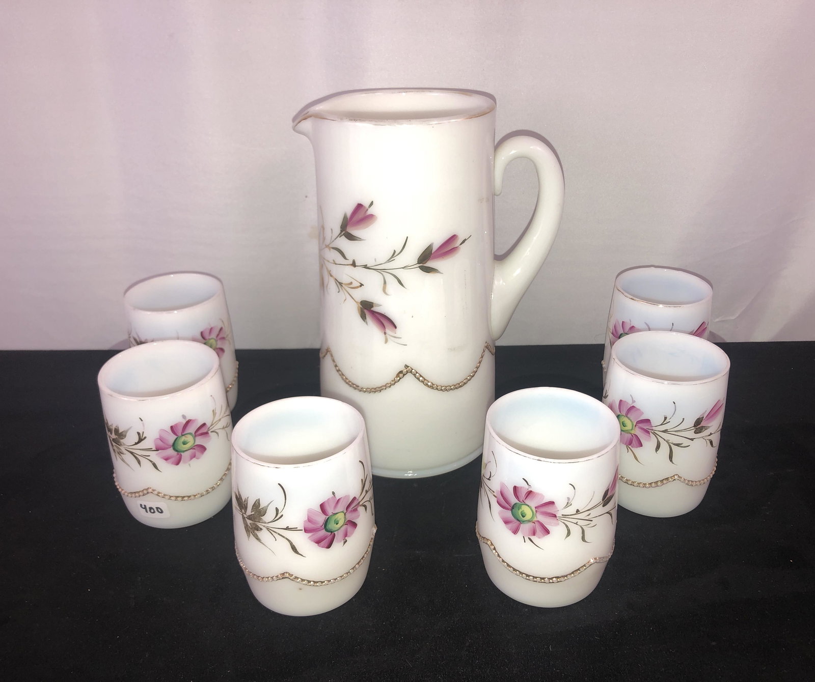 Victorian White Opaline Glass Pitcher and Tumblers: A Victorian white opaline glass pitcher with 6 matching tumblers, all pieces are handpainted and in beautiful condition.