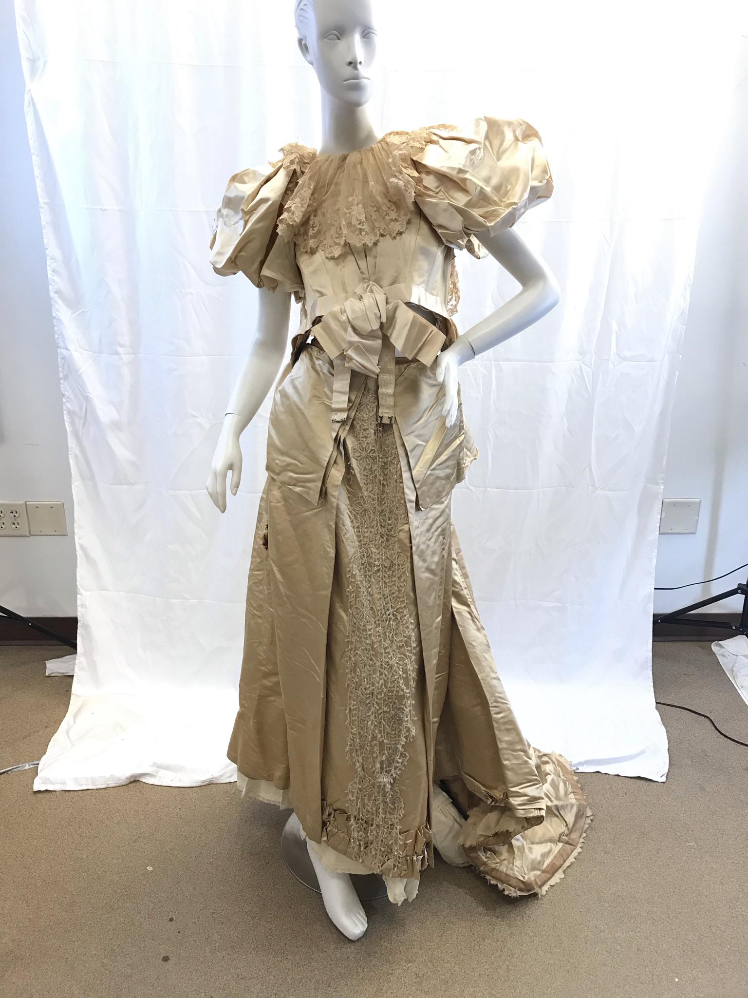 Victorian Silk Wedding Gown c.1892: This silk, lace and beaded wedding gown was handmade for the wedding of Milwaukee socialite Anita Hansen Vogel for her wedding on February 6th, 1892. It has an extensively beaded front skirt panel of 