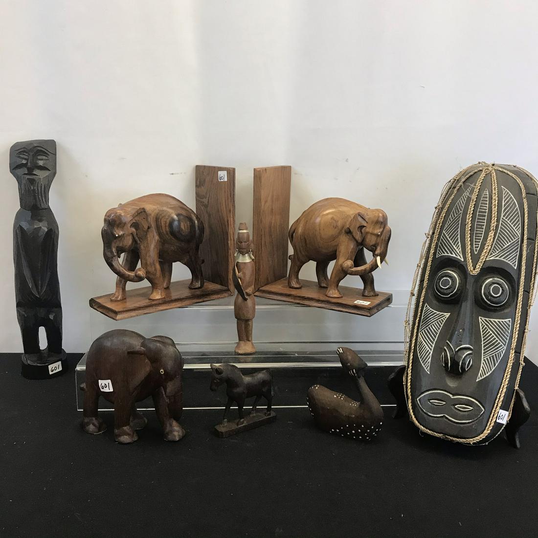 African and Asian Wood Carvings: This group of African tribal and Asian wood hand-carvings include: a pair of finely modeled rosewood elephant bookends (9" tall X 9" across X 4" deep), a single teak elephant (5.5" tall X 6" across), 