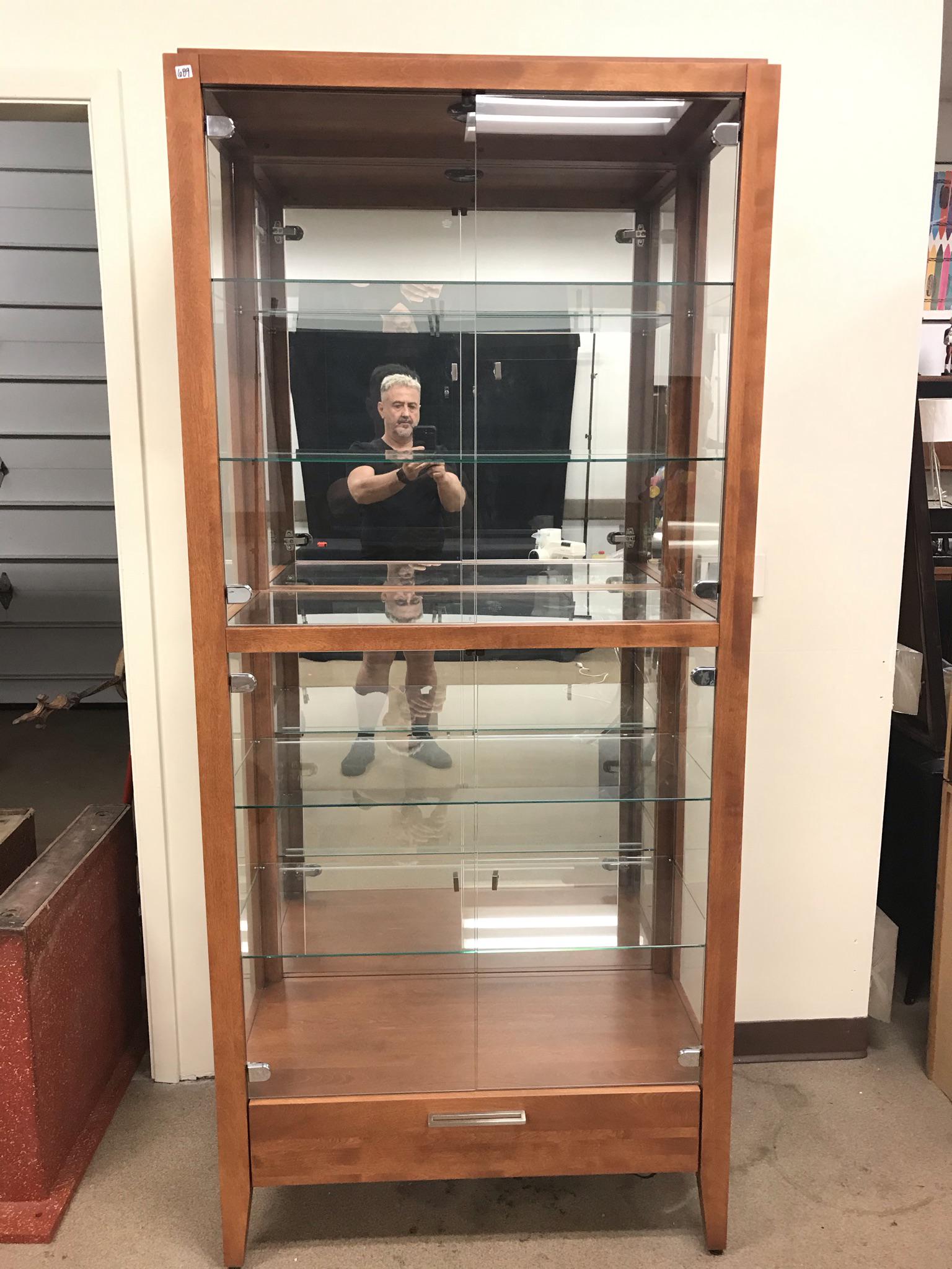 Mahogany and Glass Curio Cabinet: This quality contemporary modern single drawer curio cabinet has 2 sets of glass doors, glass shelves, and interior overhead light, and a mirrored back. It measures 77.5" tall X 35" across X 17" deep.