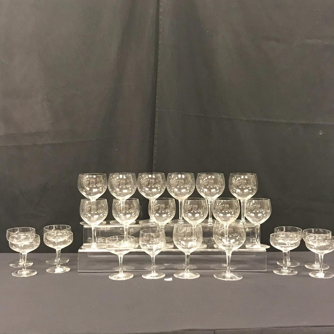 Baccarat Wine and Champagne Glasses: This group of Baccarat Crystal wine and chapagne glasses include 7 red wine glasses (6.5" tall X 3.35" acorss, 7 wine glasse (6" tall X 3.25" across), and 9 chapagne glasses (5" tall X 3.5" across.)