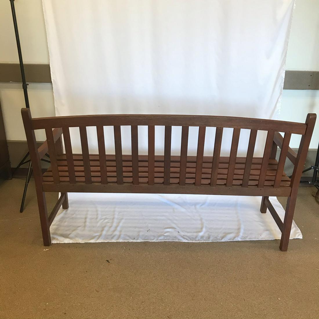 Outdoor Redwood Bench w/Cushion: This redwood patio bench has a forrest green padded cushion. In good condition, it measures 35" tall X 60" across X 21" deep.
