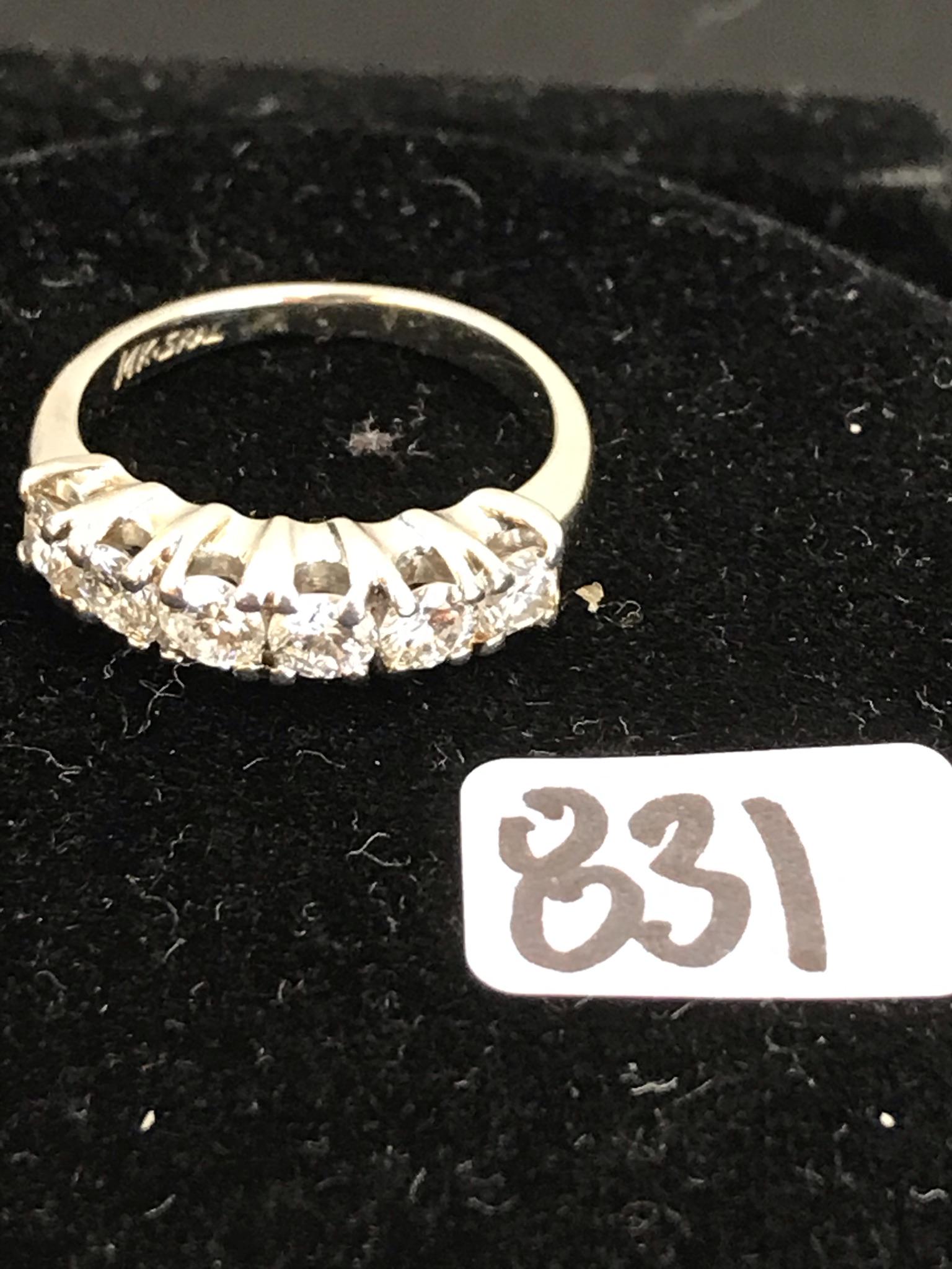 14K Gold &Diamond Wedding Band: This 14K white gold wedding band has 5 brilliant cut diamonds (apprx. .75 ct). one diamond has a chip. It weighs 3.36 grams. Ring size is 5.5.