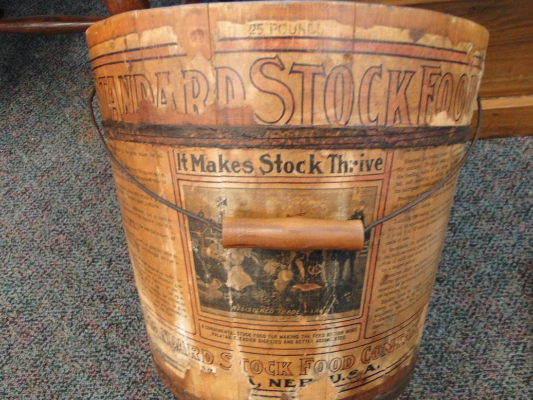A Folk Art wooden pine "Shaker pail" 12 inches tal: A Folk Art wooden pine "Shaker pail" 12 inches tall and 13 1/2 inches across. In excellent condition circa 1890. with advertisement for standard stock foods with bailed handle. Est. value $150-200