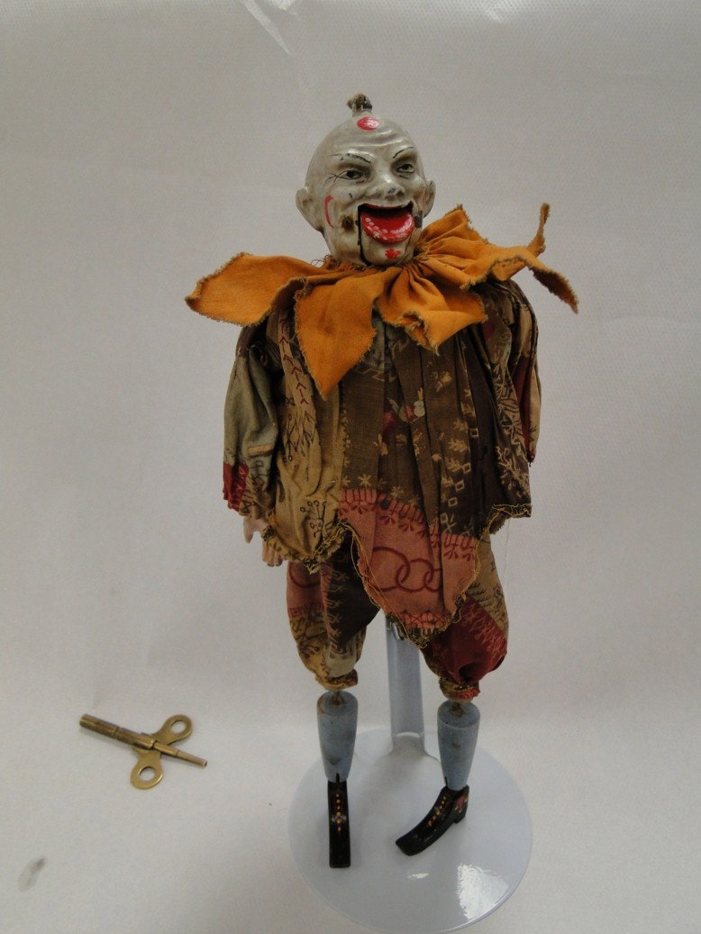 Early 1800's French clockwork keywind clown (autom: Early 1800's French clockwork keywind clown (automaton) this unusual doll or clown has a cast iron cold painted head and hands with a mouth that opens and shuts with clockwork guts- hand painted woode