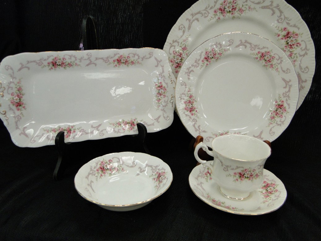 A service of china by appointment to her majesty t: A service of china by appointment to her majesty the queen china potter paragon in the Rose bouquet pattern to include, 1 relish dish, 10 cups, 9 saucers, 5 fruit bowls, 6 dessert plates and 9 dinner 