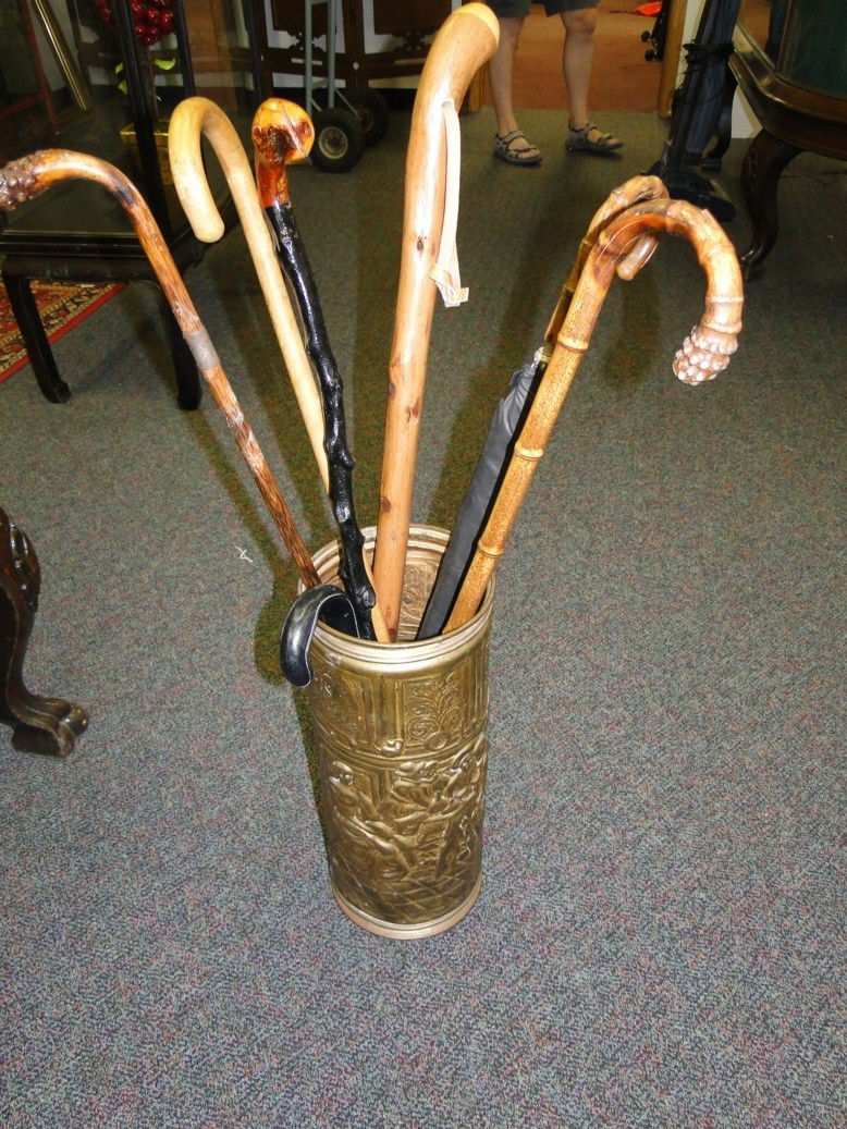 Group of canes, walking sticks and umbrellas inclu: Group of canes, walking sticks and umbrellas including Shilleaghle in a brass repousse stand. Est. value $100-125.