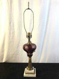 Victorian Cranberry Cutback Lamp: A Victorian cranberry cut to clear oil lamp that has been electrified. It measures 29.5" tall with harp or 18" without.