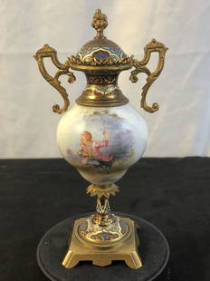 Miniature Sevres Style Covered Urn: A miniature covered urn in the style of Sevres. Urn has handpainted scene depiciting a boy, the metal work features cloisonne accents. It measures 7" tall X 3.5" across.