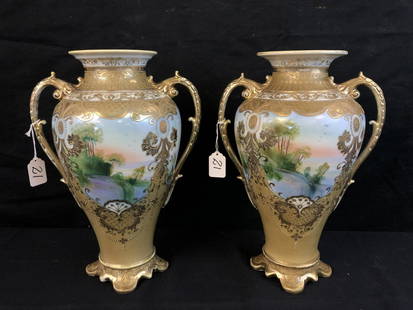 Pair of Large Matched Nippon Vases: A rare matched pair of Nippon double handled vases with heavy gold beading and scenic decorations. These vases each measure 14.5" tall X 9.5" across.