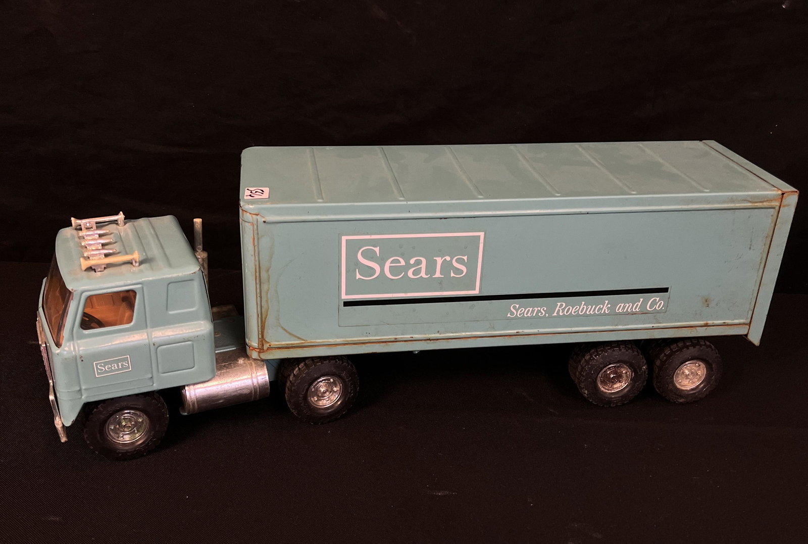 60's Turquoise Sears Semi Truck: This 1960's turquoise Sears semi truck by International in good condition. It measures 21" long X 5" across X 7" tall.