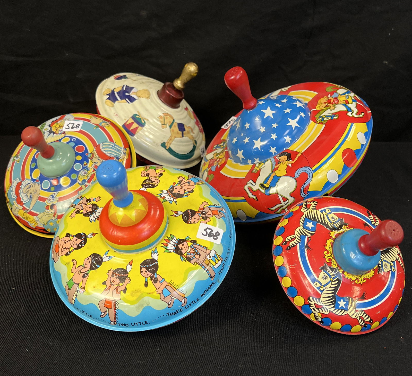 5 Tin Lithograph Spinning Tops: These 5 tin lithograph spinning metal tops are in good working conditon.
