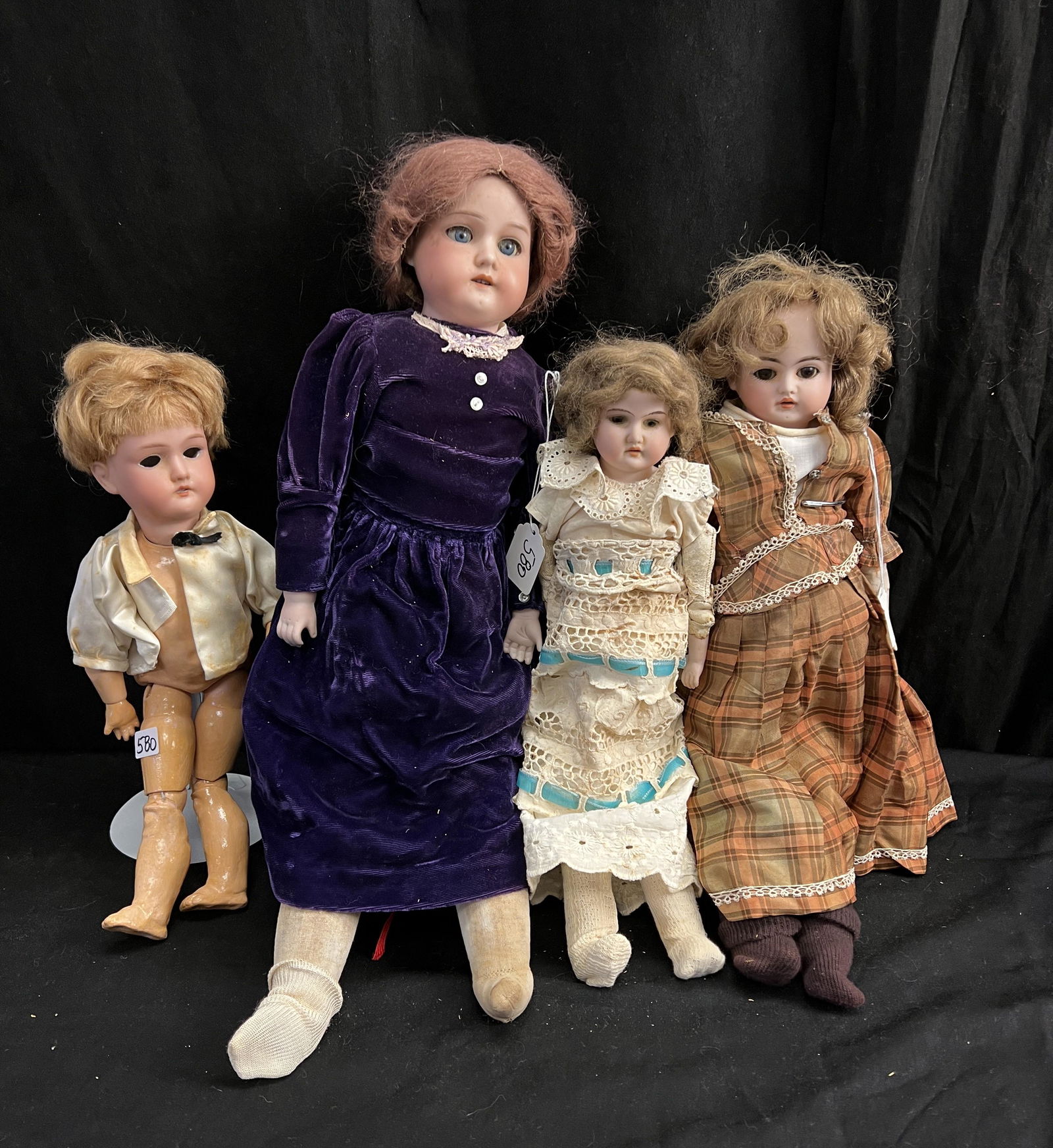 Group of German Armand Marseille Dolls, More!: This group of German Armand Marseille dolls include an Armand Marseille # 370 doll with sleep eyes, open mouth and teeth, Kid body, bisque hands and cloth calves and feet in a purple dress that measur