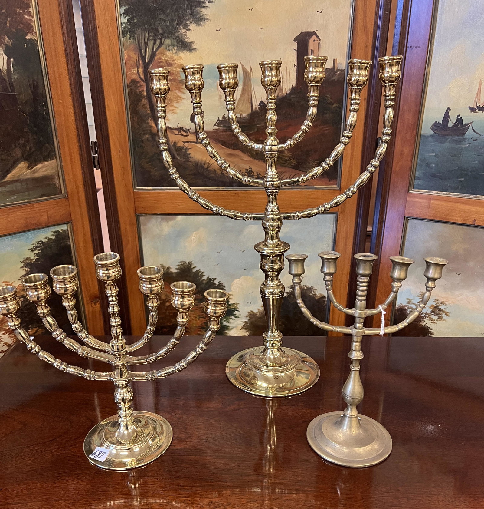 3 Antique Menorahs: 3 antique menorahs. 2 have been polished. The largest of the three measures 17.5" tall.