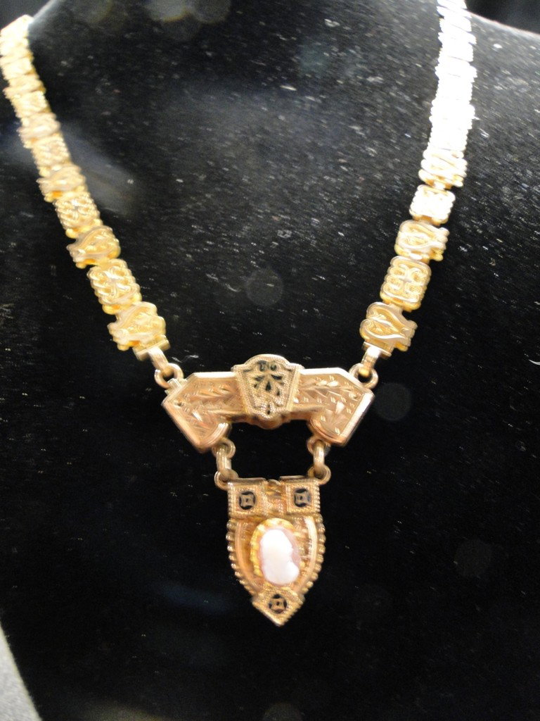 A Victorian gold necklace with carved shell cameo: A Victorian gold necklace with carved shell cameo