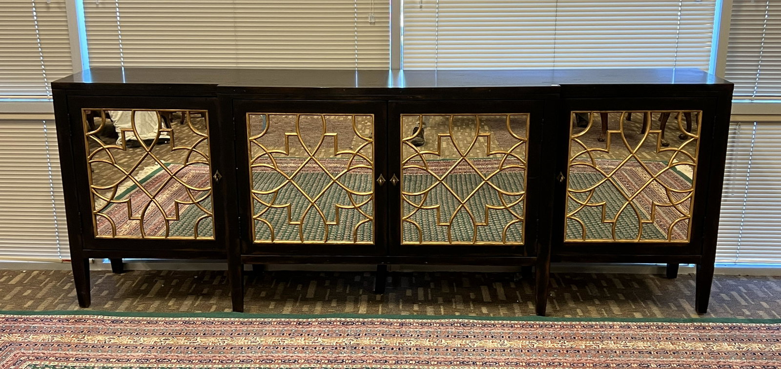 Venetian-Style Hooker Living Room Console: A Hooker Furniture Living Room Sanctuary Four Door Mirrored Console. This four-door console features antique mirrors and gold-leaf fretwork, Ebony finish, solid hardwoods and White Oak veneers. Retail