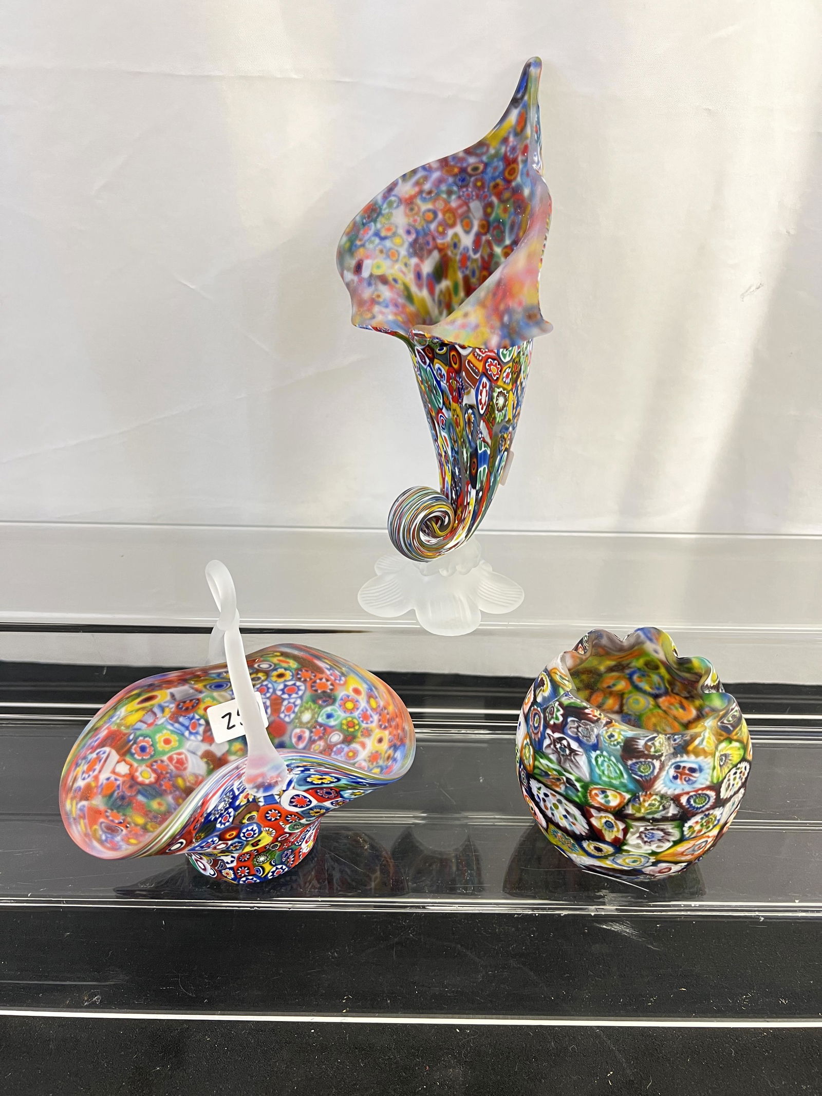 3 Murano Millefiore Vases c1960's: This group of Italian hand blown Murano glass millefiore vases inlcude a basket (5.5" tall X 5.5" across X 3" deep), a bud vase (3" tall X 3.5" across), and a Pitcher plant shaped vase (8.5" tall X 5.