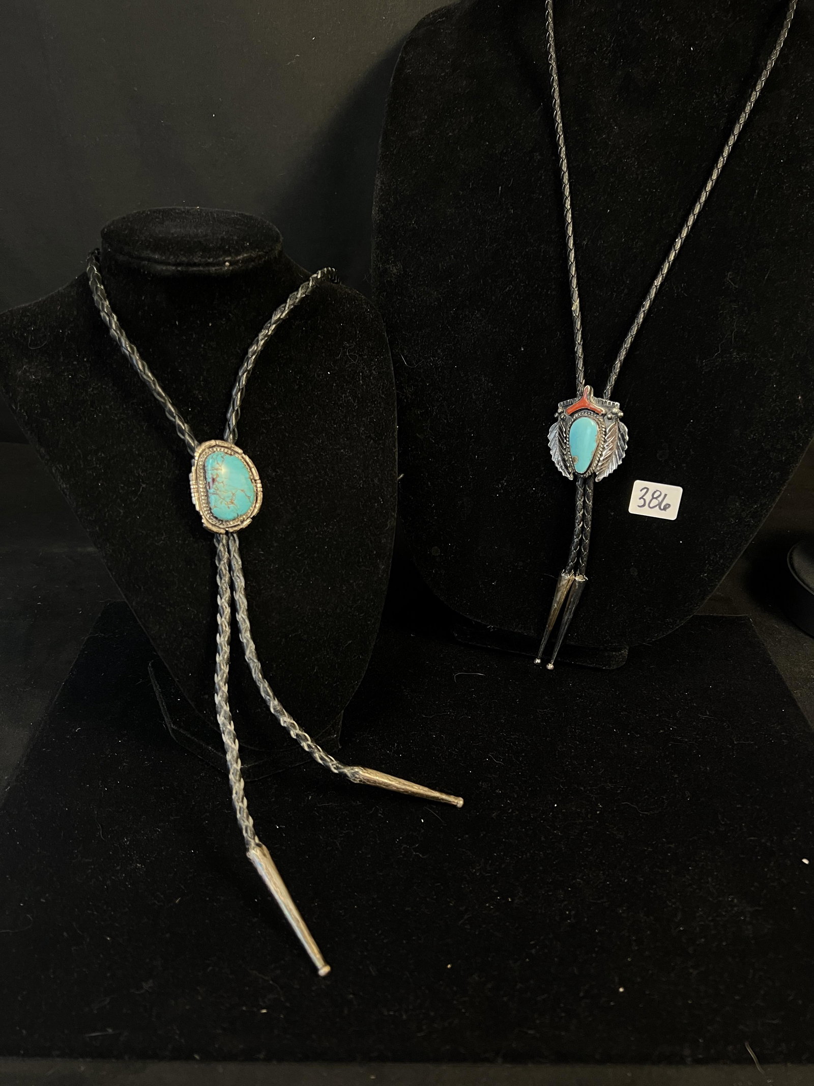 Pair of Navajo Sterling and Turquoise Bolo Ties: A pair of Navajo sterling and turquoise bolo ties. First bolo features a turquoise stone measuring 1.25" X .75", is marked sterling on back and measures 22" long. Second bolo tile features a turquoise