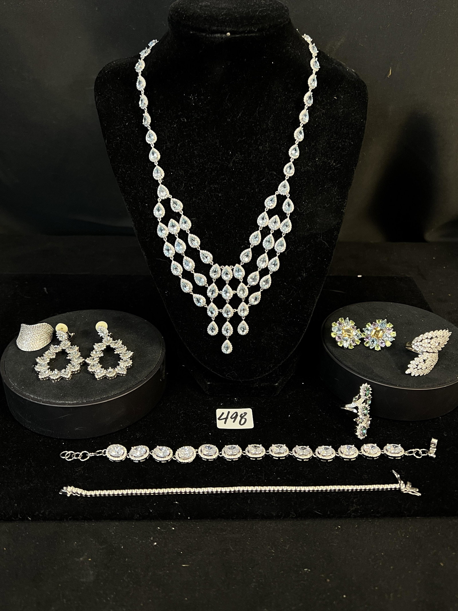 Group of Sterling and Blue Stone with CZ Jewelry: A group of 925 hallmarked jewelry. Included in this lot is an elaborate blue pear shaped stone necklace that measures 18.5" long, a matching set of earrings, a pair of round multi colored stone earrin
