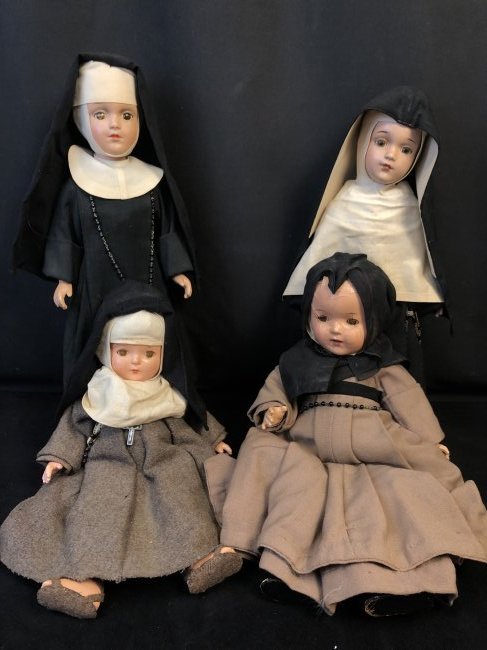 Group of 4 Nun Dolls From 1930s-40s: A group of 4 composite nun dolls dating to the 1930s-40s. All dolls feature sleep eyes, one doll has open mouth with teeth. All Dolls have full habit intact with rosary. Dolls do feature some minor ag
