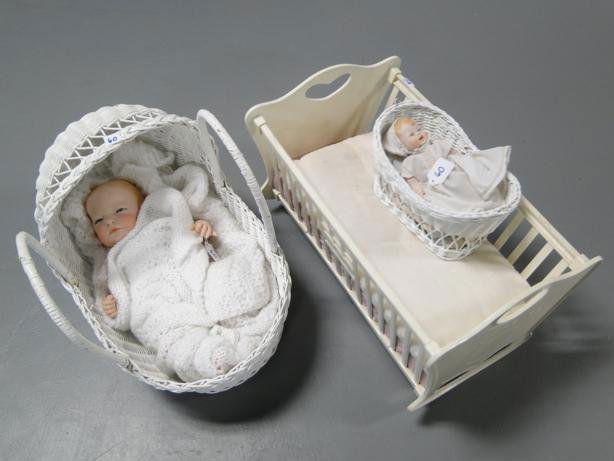 Group to include: Bisque baby doll (porcelain), con: Group to include: Bisque baby doll (porcelain), contemporary baby doll, along with 2 wicker doll beds and Tiny Tears doll bed.