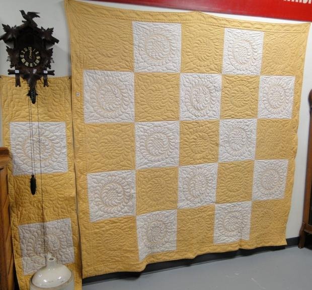 A white and yellow, pie plate stitched quilt with : A white and yellow, pie plate stitched quilt with pillow sham, in good condition 83" x 82". Estimate $150-$250