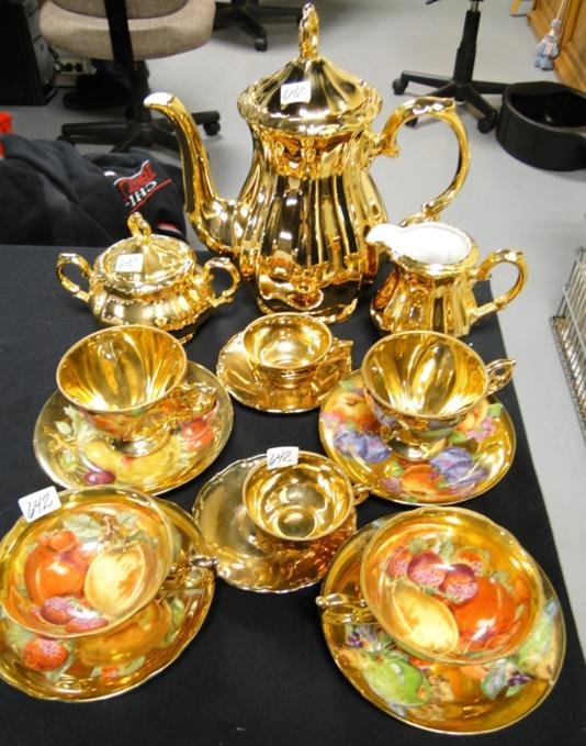 A 24k gold tea service to include: A Bavarian tea: A 24k gold tea service to include: A Bavarian tea pot, creamer and sugar, along with assorted 24K gold cups and saucers. Estimate $50-$60