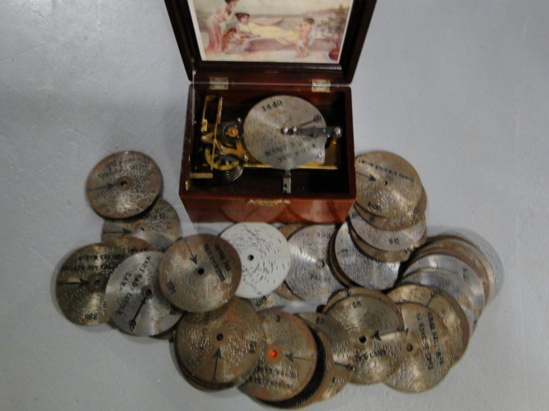 Quality 1890's - 1900's mahogany 4-1/2" disc worki: Quality 1890's - 1900's mahogany 4-1/2" disc working music box in excellent condition with 40 discs including: Ave Maria, Whistle While You Work, Auld Lang Syne, Blue Danube, The Stars and Stripes For