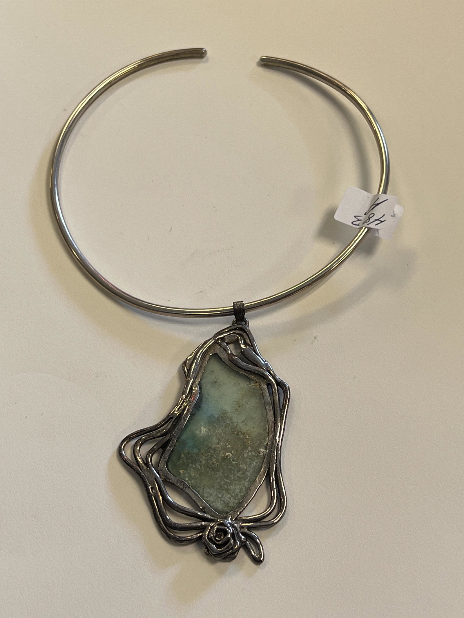 Sterling Silver Custom Choker w/ Calcite Pendant: A 1960s sterling silver custom choker and large floral pendant with natural calcite stone. The choker measures 5" across and the pendant measures 4" tall X 2" across.