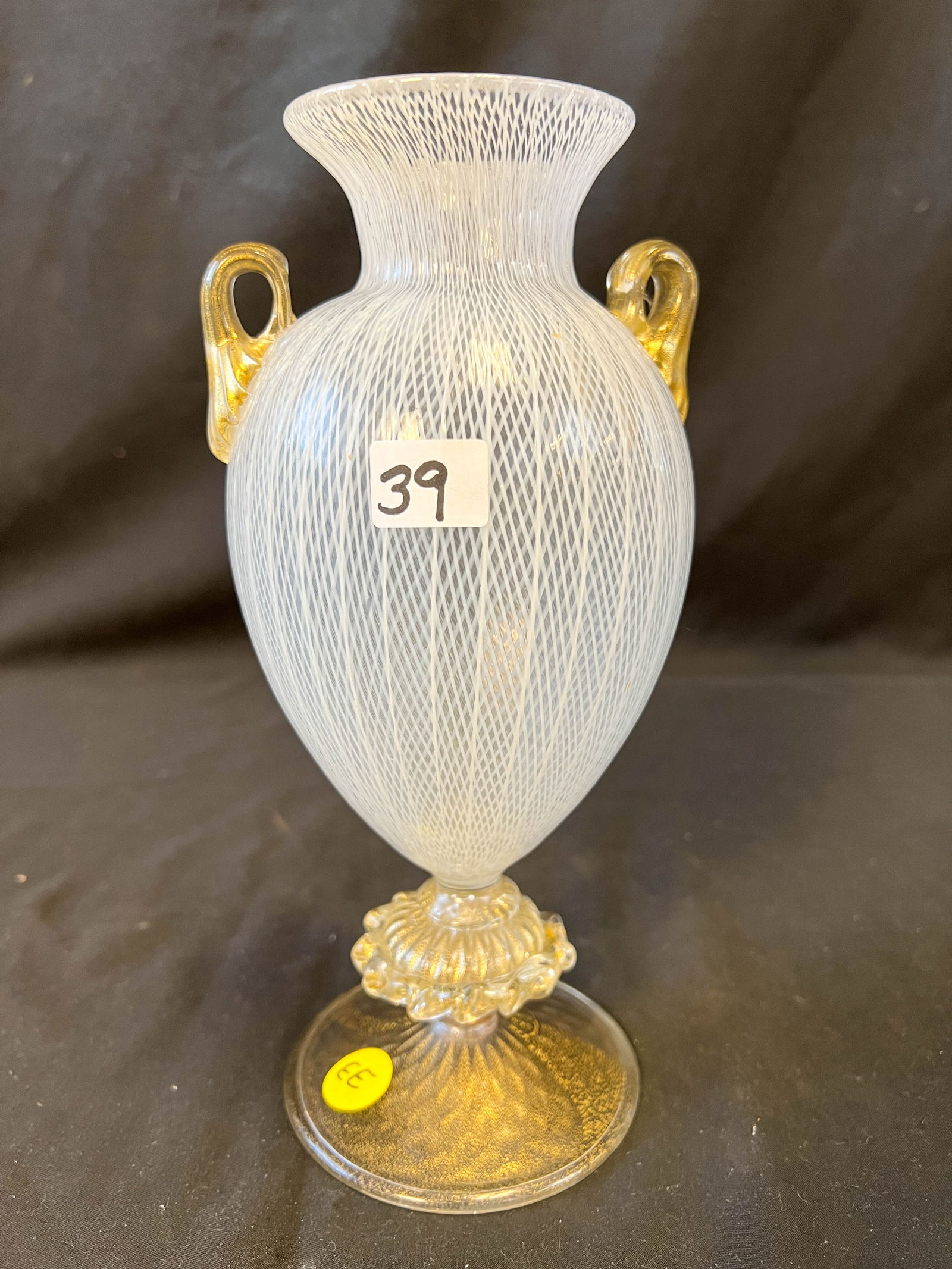 Venetian double handled Latticino vase: A Venetian double handled Latticino vase with hand blown gold flaked applied base and handles. This quaility Latticino vase measures 10"Tx4.5"W, in excellent condition.